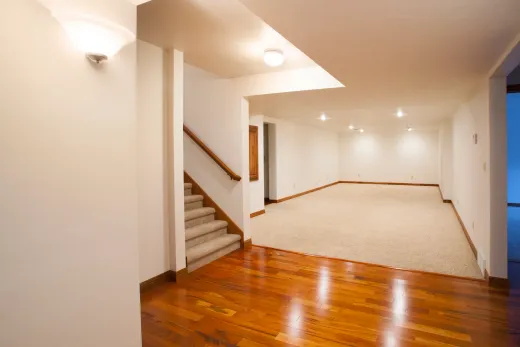Spacious finished basement suite with carpet and hardwood, ready for a tenant