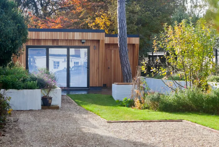Detached cedar garden suite in a landscaped Ontario backyard by Leo Constra