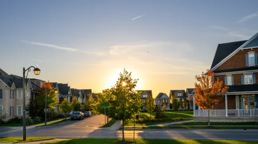 New detached homes at sunset in a GTA suburb, where renovation permit fees differ by municipality