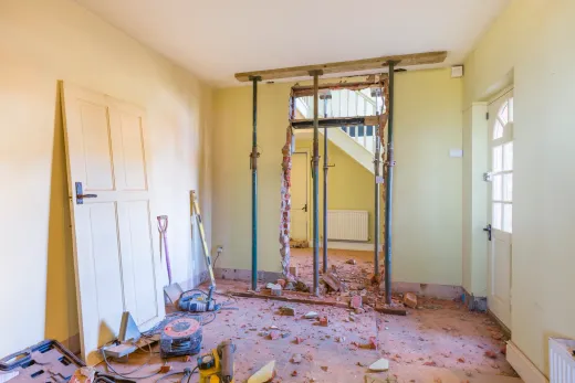 Interior renovation in progress with framing and fresh drywall awaiting inspection