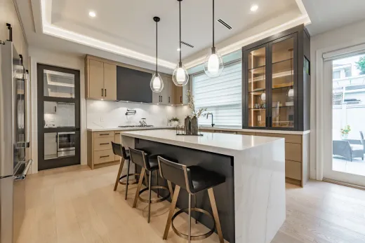Renovated kitchen with a large white island, the open layout many Etobicoke bungalow owners are after