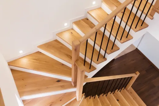 Solid oak staircase with new treads and modern railing after recapping