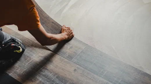 Resilient plank flooring being installed — the moisture-tolerant base layer beneath rubber tiles in many GTA basement gyms